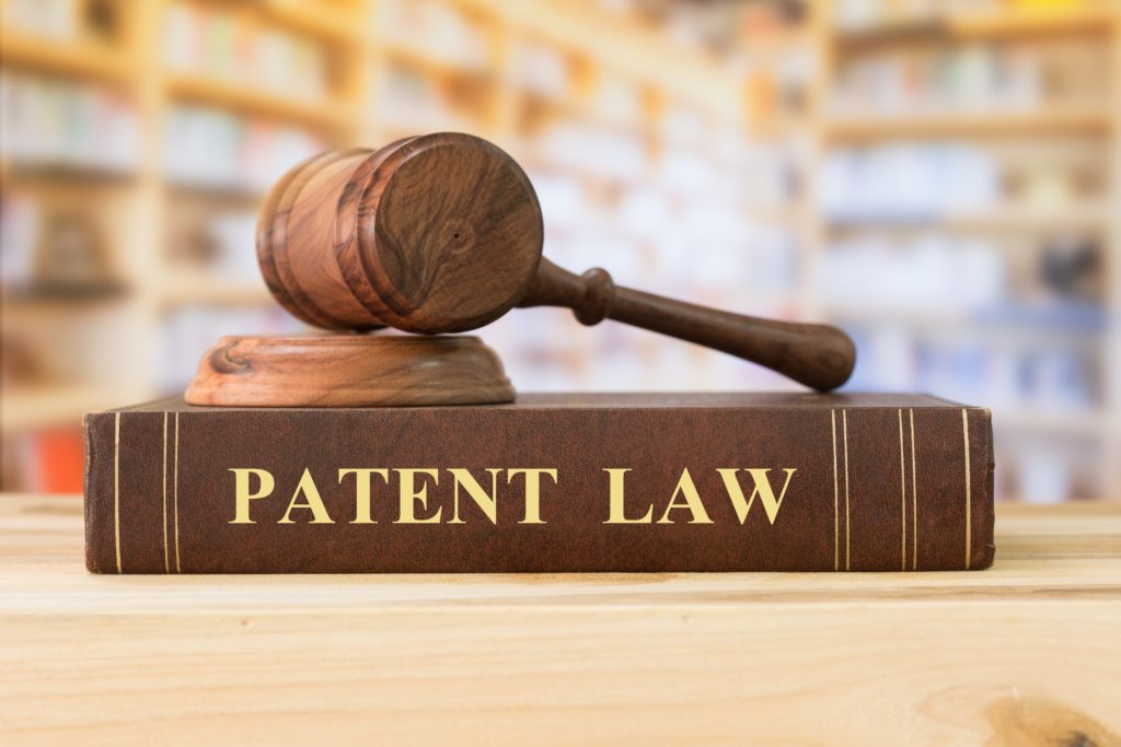 Wooden Judges Hammer On Patent Law Book