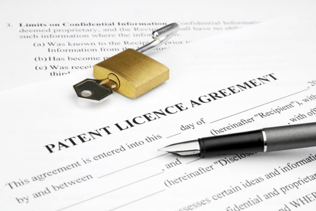 Patent Licence Agreement Document With A Pen And Safety Lock On Top